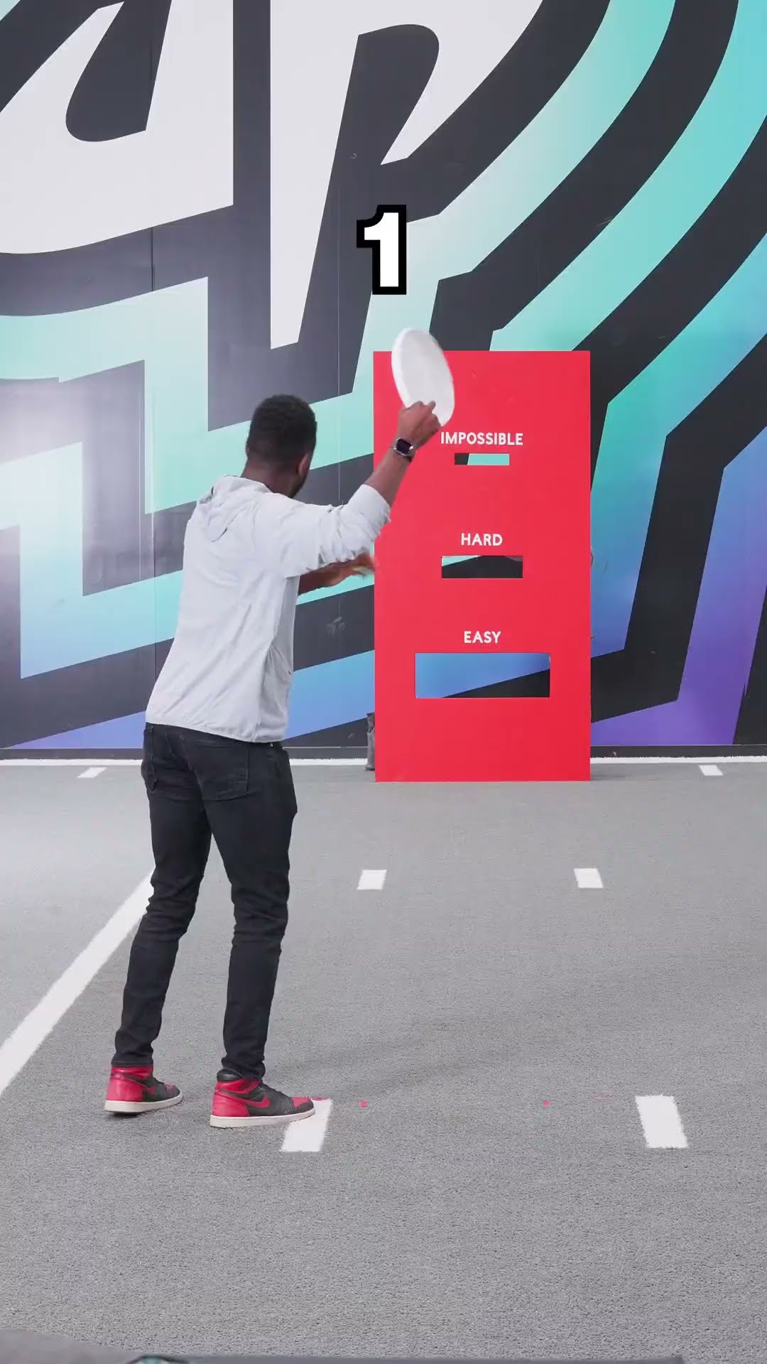 Dude Perfect's Short: two creators beside a red Easy/Hard/Impossible board